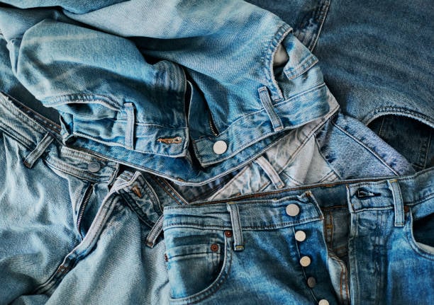 a pile of blue denim jeans. stock photo